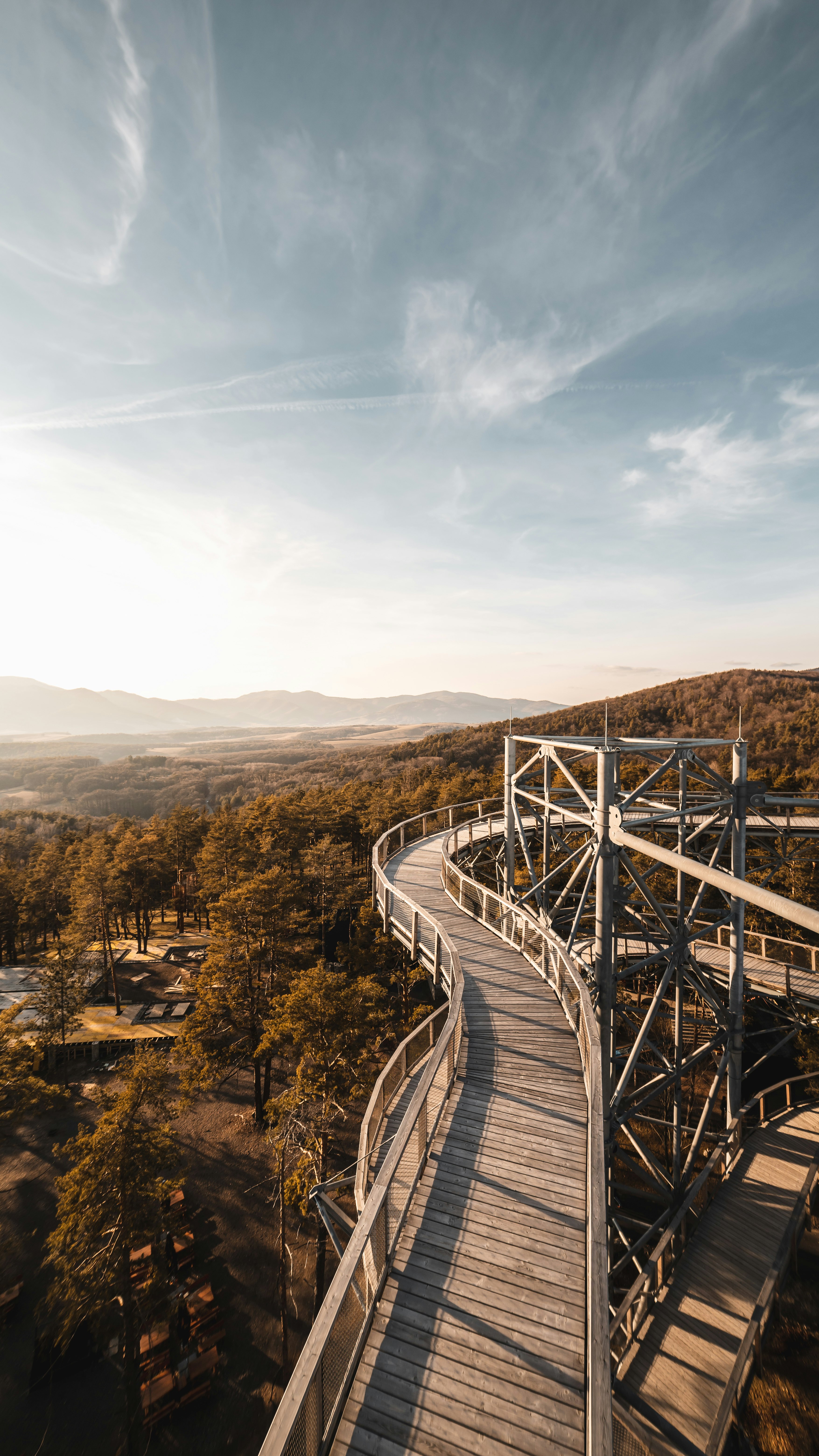 gray wooden bridge over the mountains during daytime